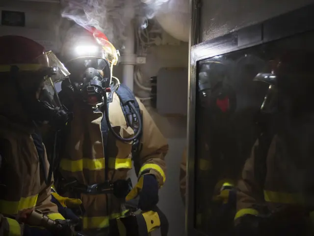 The image shows a group of firefighters wearing gas masks and helmets, standing in front of a door...