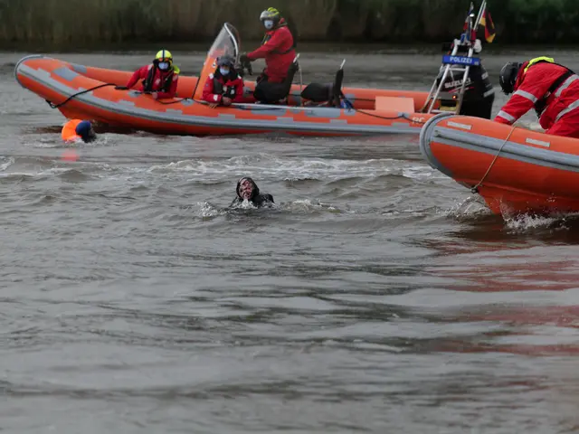 The image shows a group of people in an inflatable boat on a river, with two people in the water in...