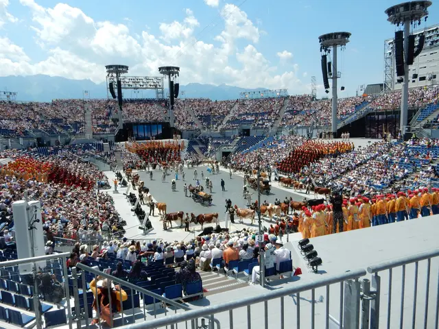 The image shows a large crowd of people watching a rodeo in a stadium. We can see a group of people...