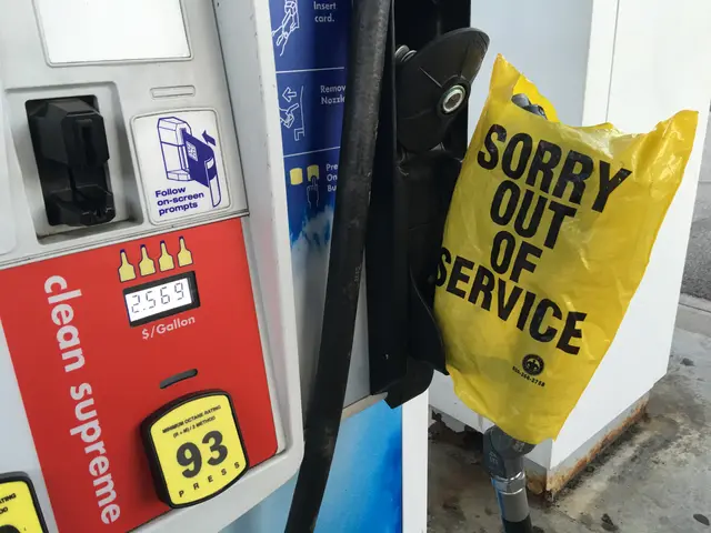 The image shows a gas pump with a sign that reads "Sorry Out of Service" and a yellow cover with...