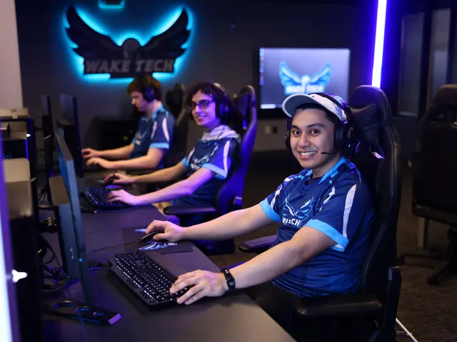 The image shows a group of people sitting at a desk in front of computers, wearing headsets and...