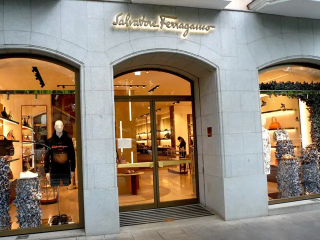 The image shows a Salvatore Ferragamo store in Milan, Italy. The building has glass walls and...