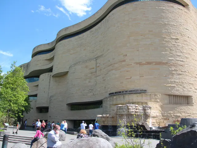 The image shows the Guggenheim Museum in New York City. It is a large building with windows and...