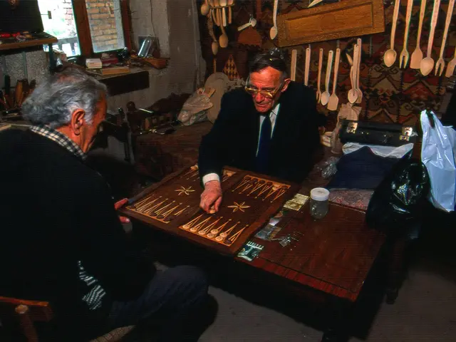 The image shows two men sitting at a table playing a game of backgammon. On the table there are...