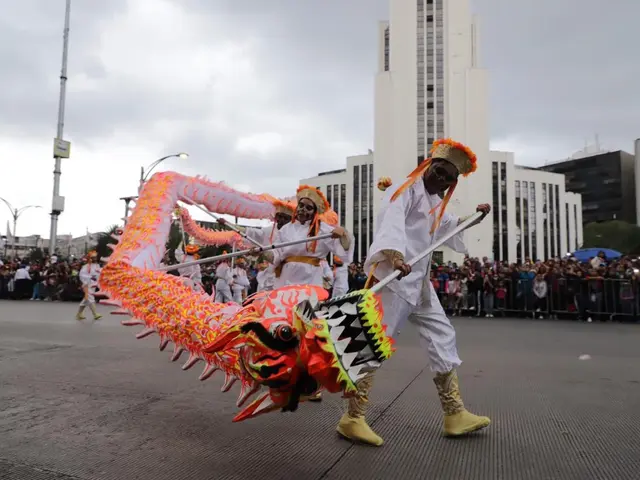 The image shows a group of people wearing costumes and holding sticks in their hands, performing a...