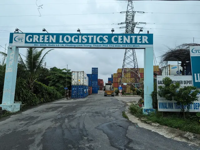 The image shows the entrance to the Green Logistics Center in Ho Chi Minh City, Vietnam. There is...