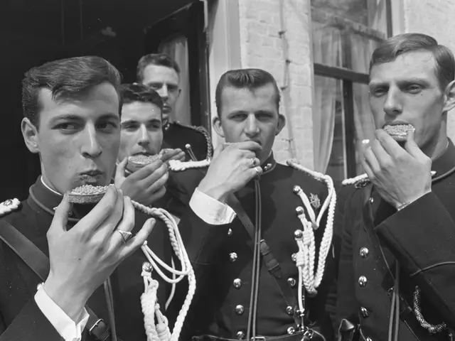 The image shows a group of men in military uniforms eating food in front of a building with windows...