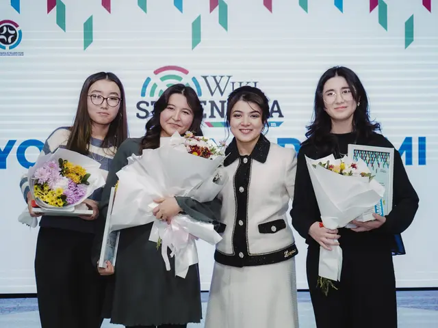 The image shows a group of four women standing next to each other, each holding a bouquet of...