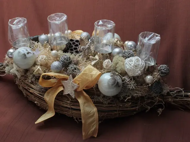 The image shows a festive Christmas centerpiece with a basket filled with ornaments and candles on...