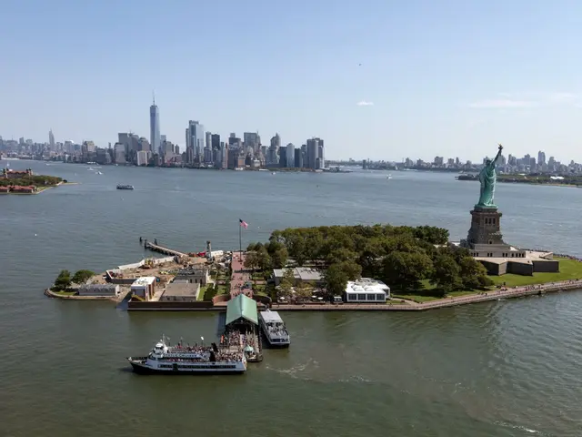 The image shows the iconic Statue of Liberty in New York City, surrounded by the Hudson River. The...