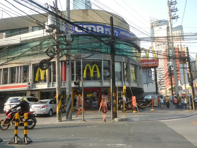 The image shows a busy street in Bangkok, Thailand, with a McDonald's restaurant in the background....