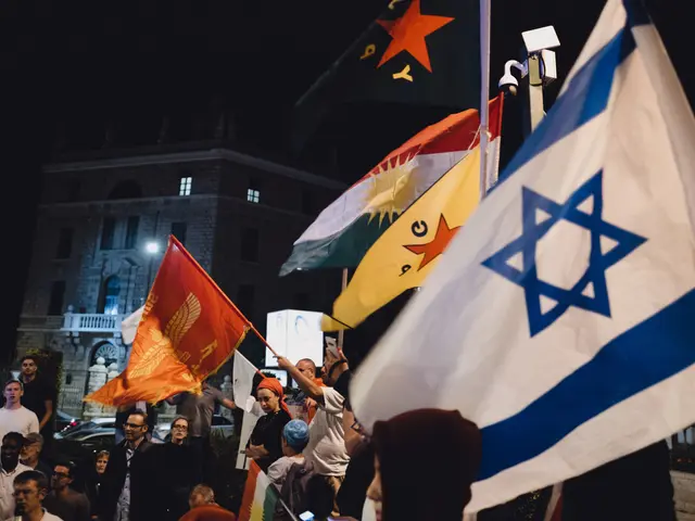 The image shows a group of people standing in front of a building, holding flags in their hands....