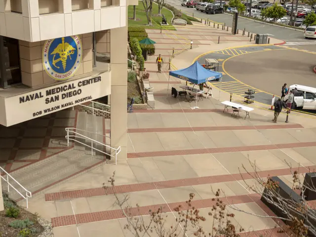 The image shows the Naval Medical Center in San Diego, California. It is a building with a logo and...