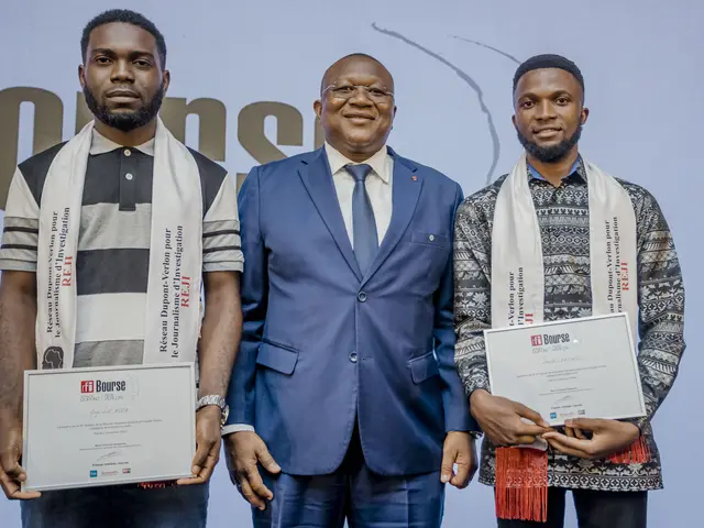 The image shows three men standing next to each other, each holding a certificate in their hands....