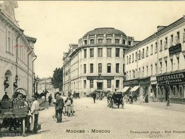 The image shows an old black and white photo of a city street in Moscow, Russia. There are people...