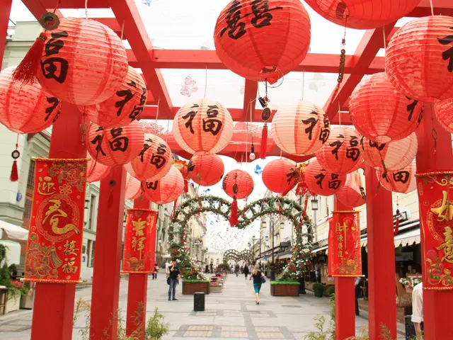 The image shows a bustling Chinese New Year market in Singapore, with red lanterns hanging from the...