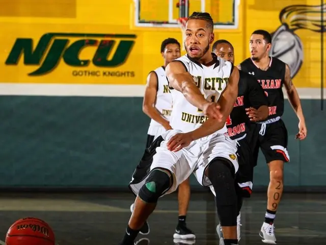 The image shows a group of men playing a game of basketball on a court, with a wall in the...