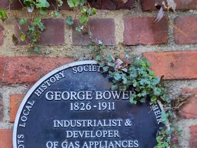 The image shows a plaque on the side of a brick building that reads "George Bower, Industrialist &...