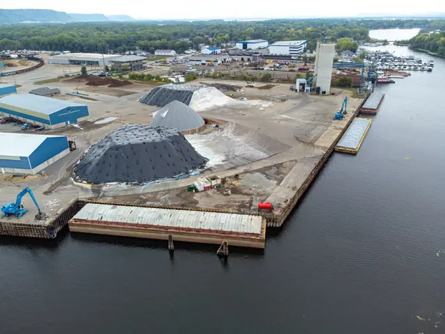 The image shows an aerial view of a large body of water with a dock in the middle, surrounded by...