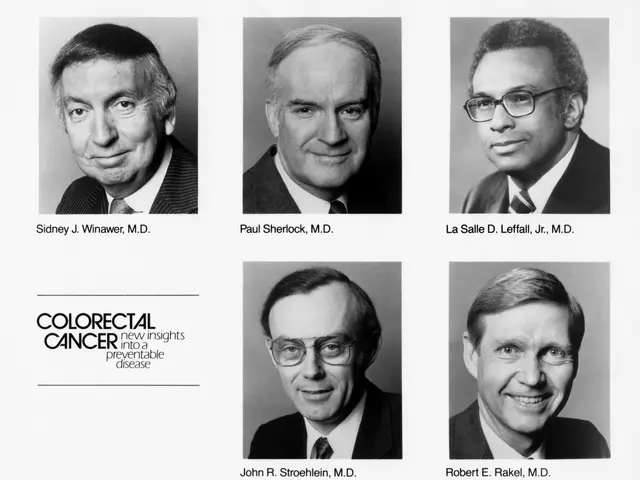 The image shows a black and white photo of six men in suits and ties, each wearing spectacles, with...