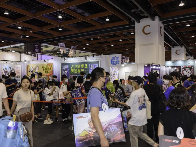 The image shows a large group of people standing in front of a booth, some of them holding bags and...