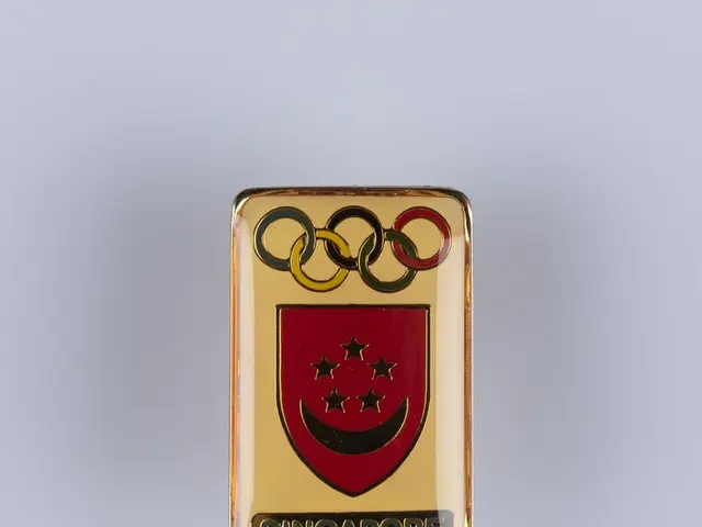 The image shows a Singapore Olympic logo pin on a white surface. The logo consists of a red and...