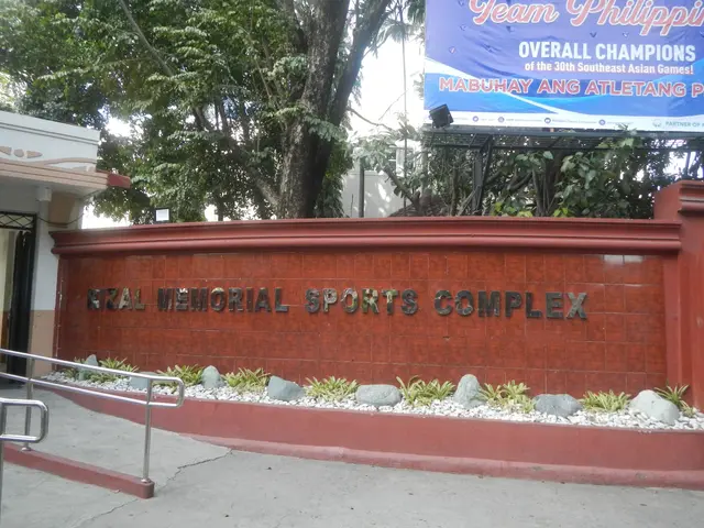 The image shows the entrance to the National Memorial Sports Complex in Manila, Philippines. On the...