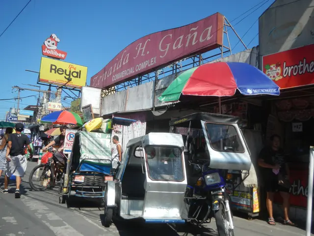 The image shows a bustling street in Manila, Philippines, with a variety of vehicles on the road,...
