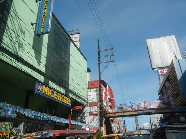 The image shows a bustling city street filled with lots of traffic, including vehicles on the road,...