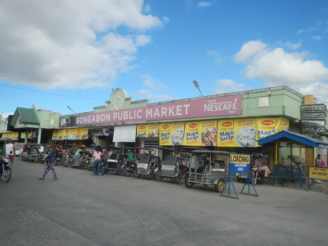 The image shows a bustling bongabon public market in the Philippines, with vehicles on the road,...