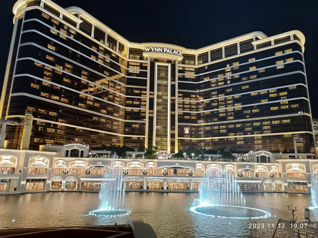 The image shows Wynn Palace Hotel and Casino in Las Vegas, Nevada. It is a large building with...