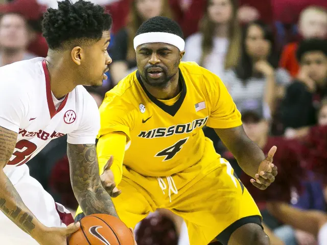 The image shows two men playing basketball on a court with a crowd of people watching. The man on...