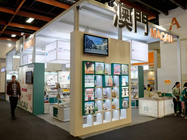 The image shows a group of people standing in front of a trade show booth, which is part of the...