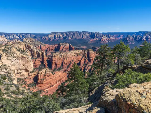 The image shows a breathtaking view of the red rocks of Sedona, Arizona from the top of a cliff....