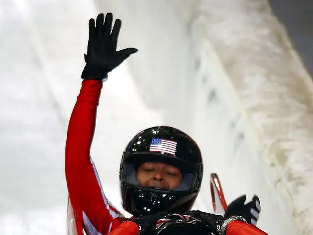 The image shows two bobsleds in action at the Olympics, with one of them wearing a helmet and...