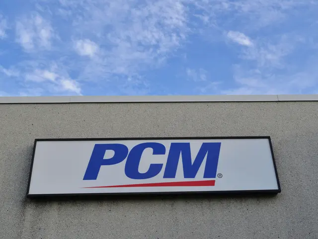 The image shows a PCM sign on the side of a building, with a board attached to the wall displaying...