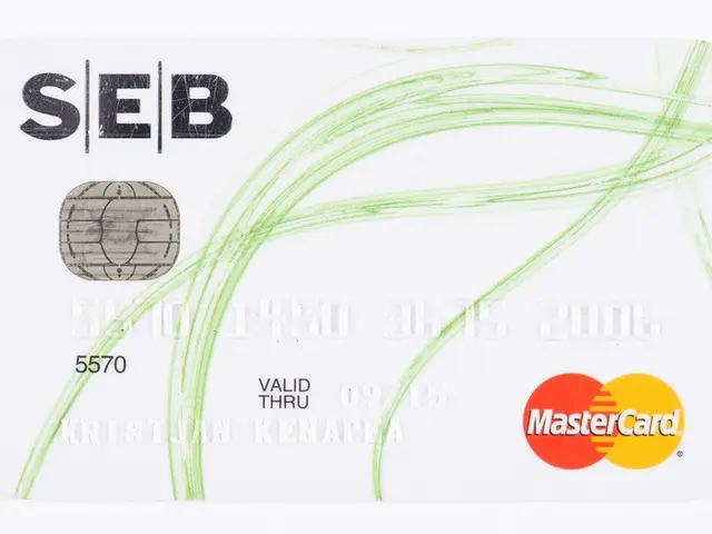 The image shows a white Mastercard with a green and white design on it against a white background....