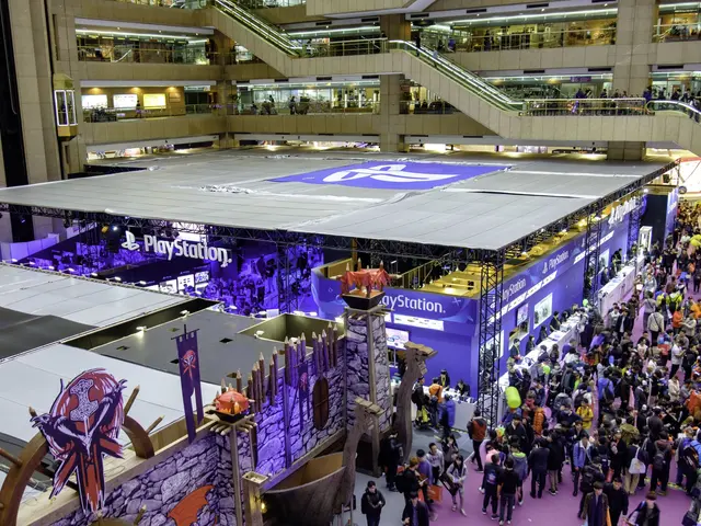 The image shows a large crowd of people standing in a large building with escalators, railings,...