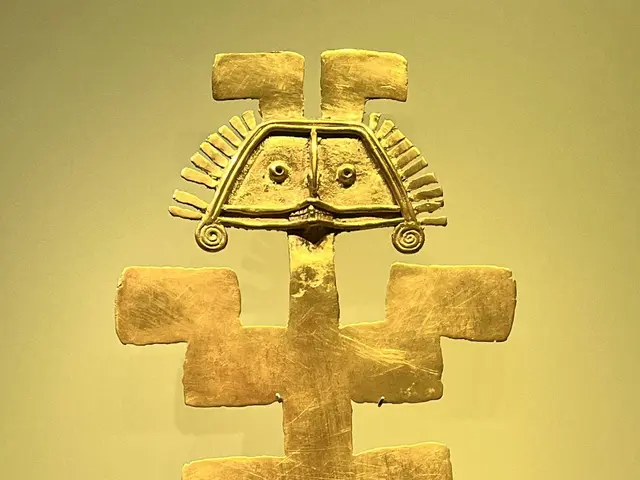 The image shows a gold anchor on display in a glass case, which is believed to be a representation...