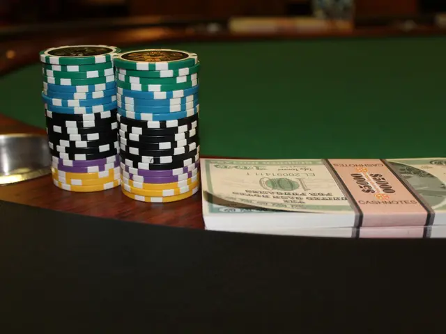 The image shows a poker table with a stack of poker chips on top of it, along with some currency...