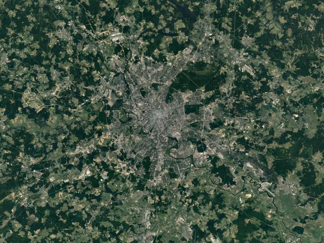 The image shows a satellite view of the city of London at night, with trees visible in the...