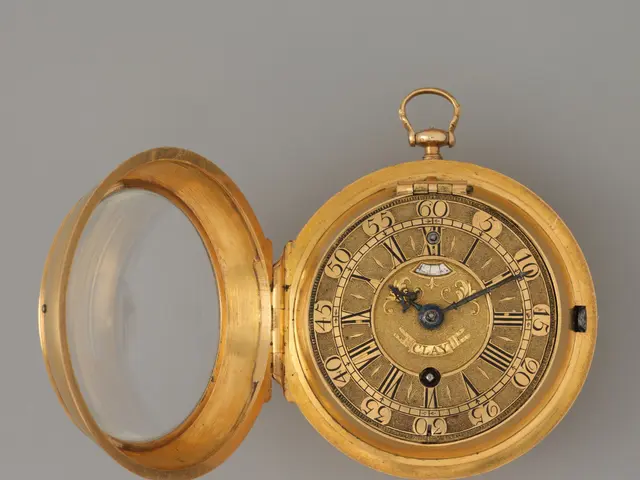 The image shows a gold pocket watch with a white background. The watch has a dial with Roman...