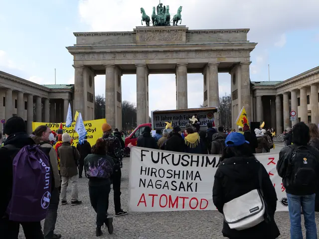 The image shows a group of people standing in front of the Brandenburg Gate in Berlin, Germany,...