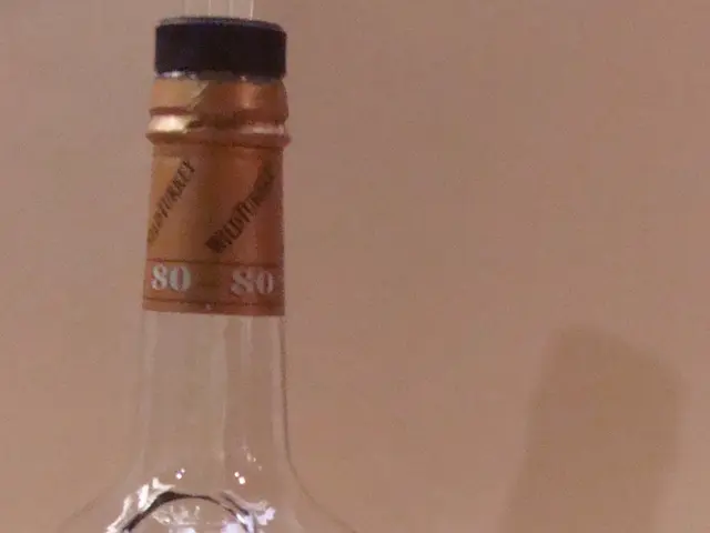 The image shows a bottle of Austin Nichols Wild Turkey Kentucky Straight Bourbon and a glass of the...