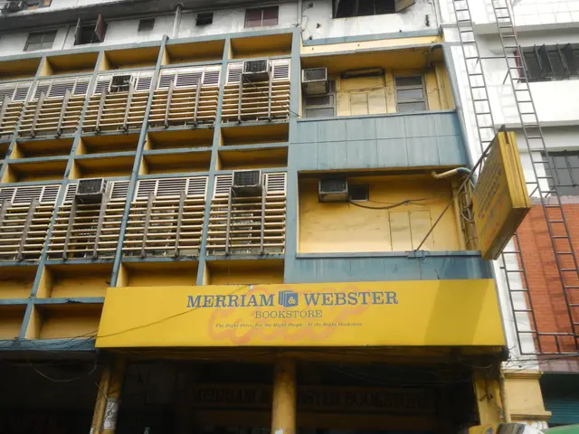 The image shows a building with windows, air conditioners, a signboard with the text "Merriam &...