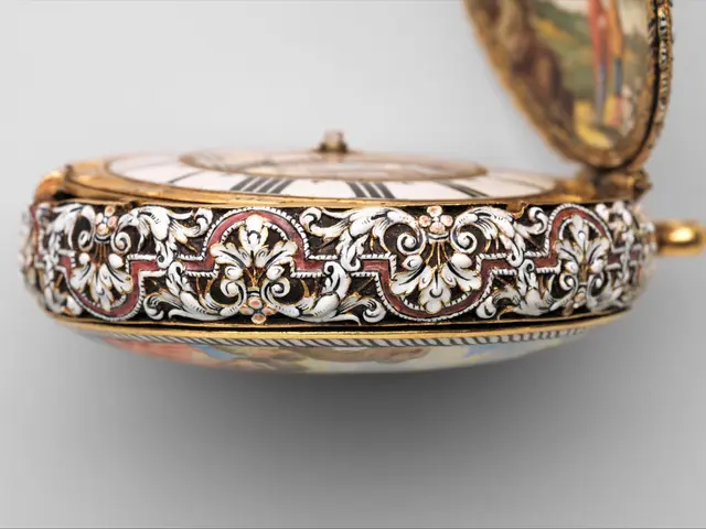 The image shows a close up of a pocket watch with a painting on it. The watch is encrusted with...