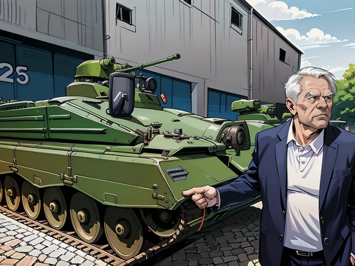 Armin Papperger, head of Rheinmetall, stands beside a revamped Marder infantry combat vehicle. Rheinmetall boss Armin Papperger in front of a refurbished Marder infantry fighting vehicle