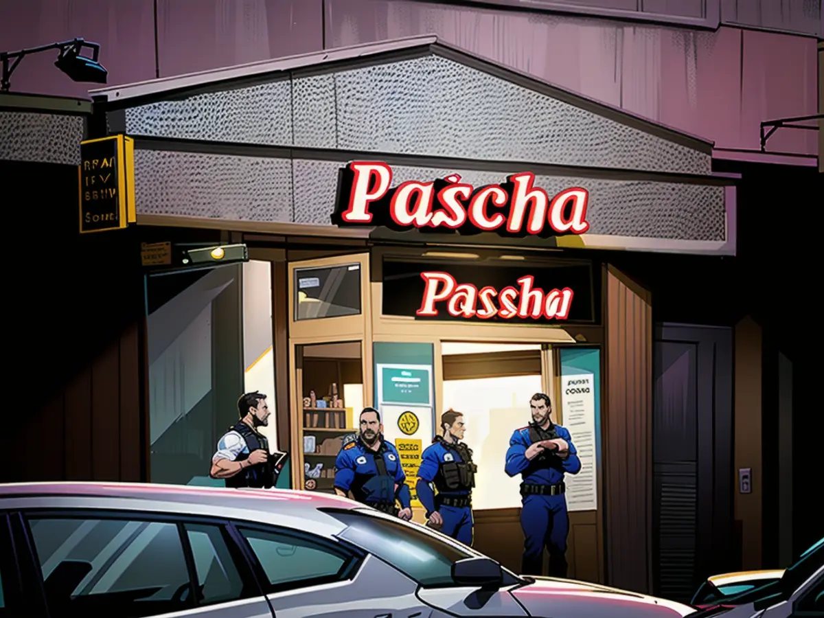 Police officers stand in front of the entrance to the 